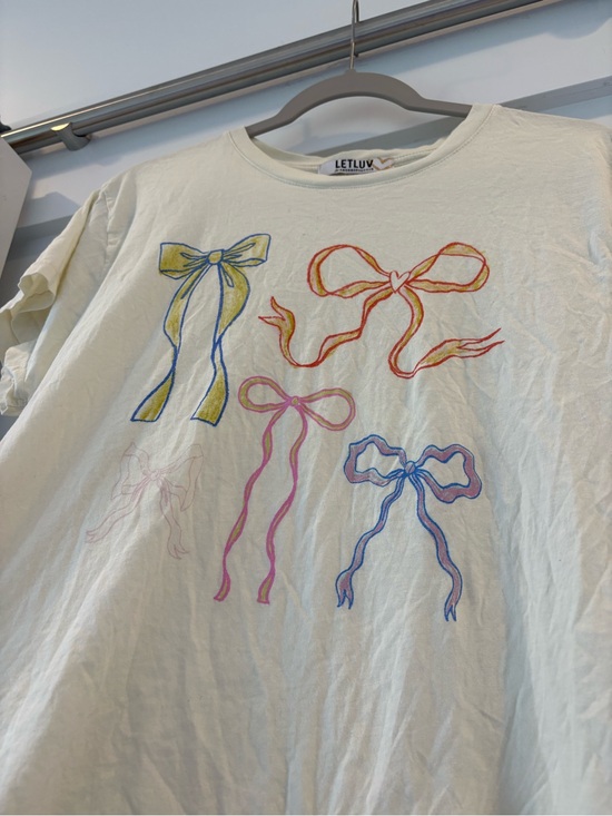Anthropologie Tops - Super cute Anthropologie Cream Tee with Multicolor Bow 🎀
